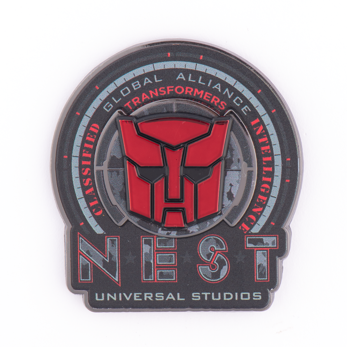 Pin escudo N.E.S.T. Transformers